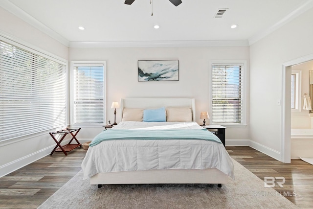 bedroom with ensuite bath, ceiling fan, crown molding, and dark wood-type flooring