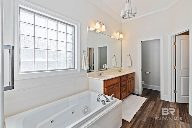 bathroom with hardwood / wood-style floors, plenty of natural light, a washtub, and a notable chandelier