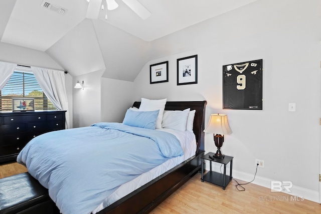 bedroom featuring ceiling fan, light hardwood / wood-style floors, and vaulted ceiling