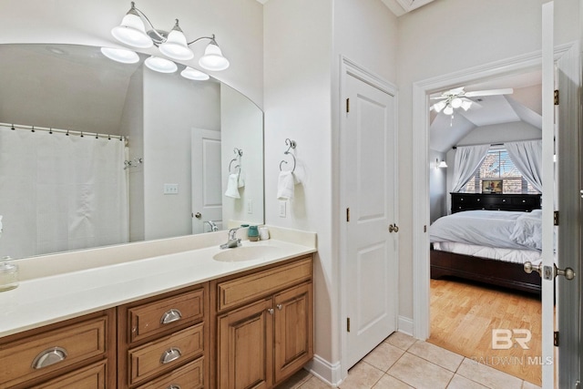 bathroom with tile patterned flooring, ceiling fan, and vanity