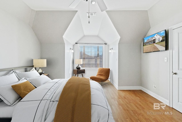 bedroom featuring ceiling fan, vaulted ceiling, and light wood-type flooring