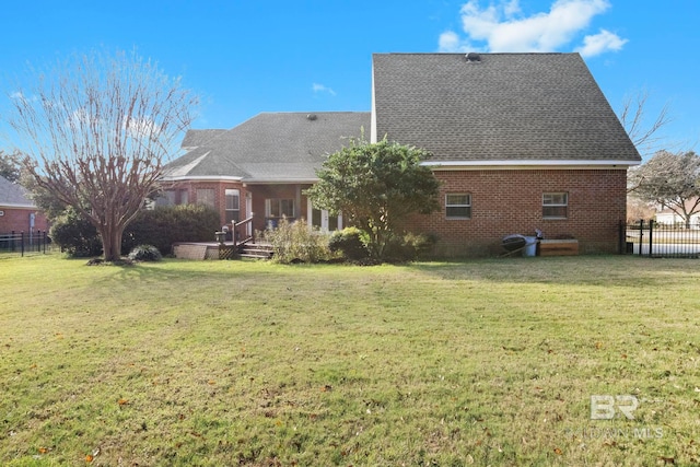 back of house featuring a yard