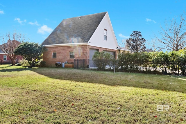 view of side of property featuring a garage and a lawn