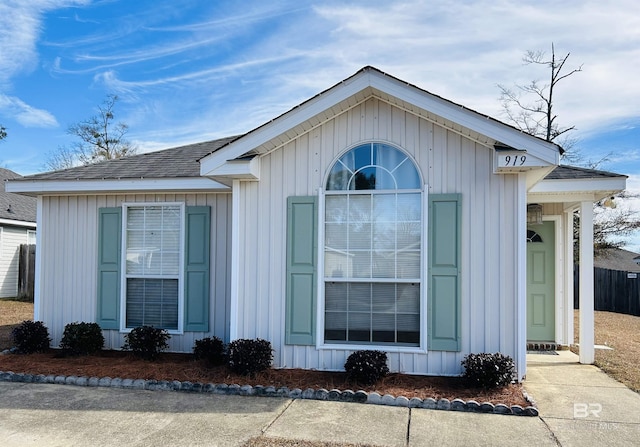 view of home's exterior with board and batten siding and roof with shingles