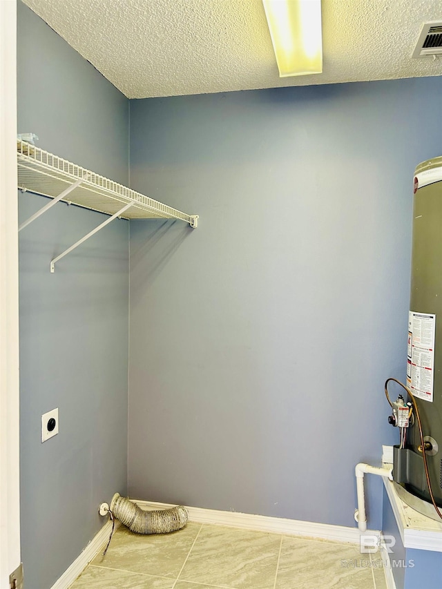 laundry room with baseboards, visible vents, hookup for an electric dryer, a textured ceiling, and gas water heater