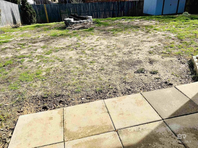 view of yard with an outdoor structure and fence