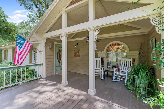 deck with ceiling fan and covered porch