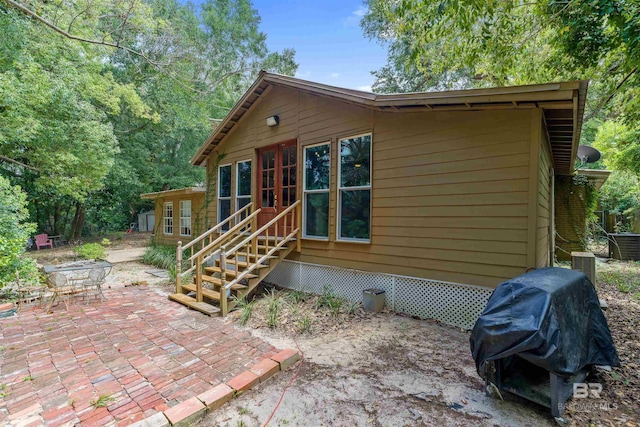 rear view of property featuring a patio area and central AC