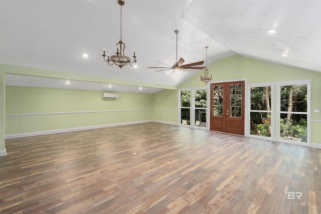 unfurnished living room featuring an AC wall unit, ceiling fan, wood-type flooring, and vaulted ceiling