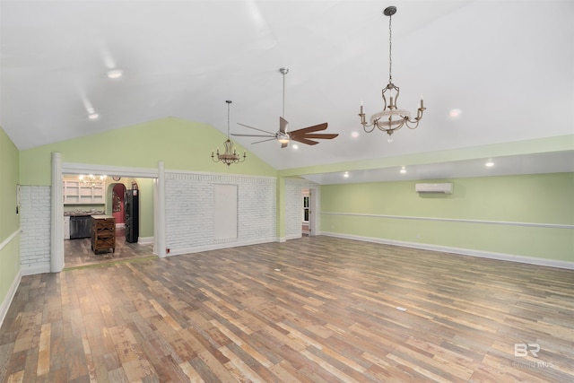 unfurnished living room featuring wood-type flooring, an AC wall unit, ceiling fan, and lofted ceiling