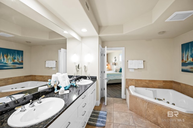 28107 Perdido Beach Blvd Unit D 503, Orange Beach, AL 36561 - ensuite bathroom featuring visible vents, double vanity, a sink, ensuite bathroom, and a jetted tub