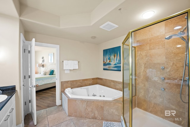 28107 Perdido Beach Blvd Unit D 503, Orange Beach, AL 36561 - ensuite bathroom with vanity, ensuite bath, a stall shower, tile patterned flooring, and a garden tub