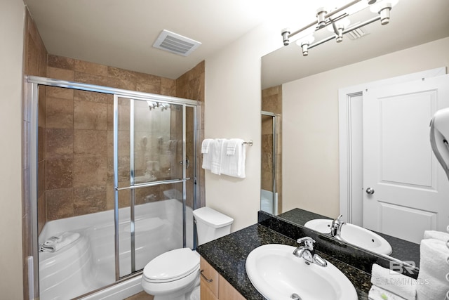 28107 Perdido Beach Blvd Unit D 503, Orange Beach, AL 36561 - bathroom with vanity, a shower stall, toilet, and visible vents