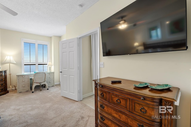 home office with baseboards, light colored carpet, and a textured ceiling