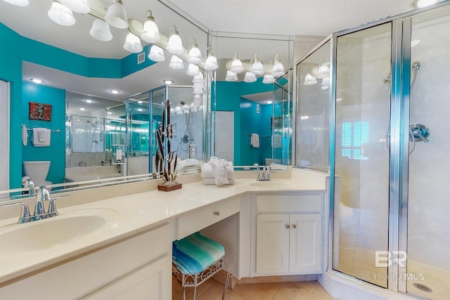 full bathroom with tile patterned floors, a shower stall, double vanity, and a sink