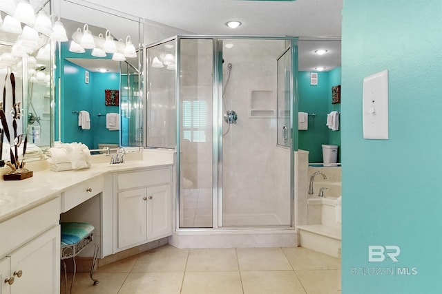 full bath with tile patterned floors, a garden tub, a shower stall, and vanity