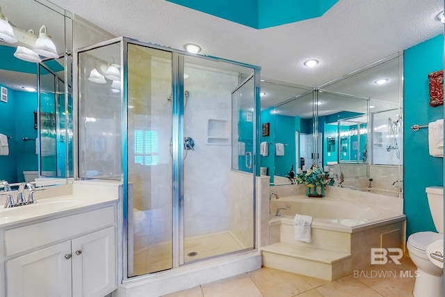 bathroom featuring tile patterned flooring, toilet, a garden tub, a stall shower, and a textured ceiling