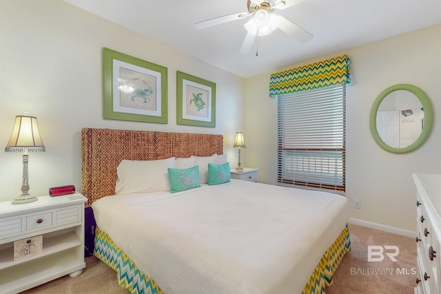 bedroom with light colored carpet, baseboards, and ceiling fan