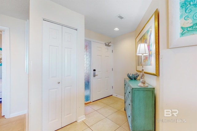 entrance foyer featuring light tile patterned flooring, visible vents, and baseboards