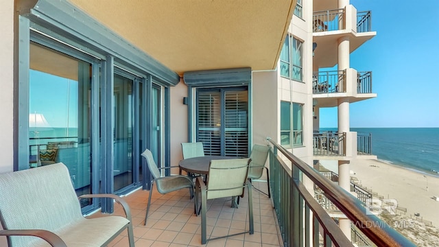 balcony with a view of the beach and a water view