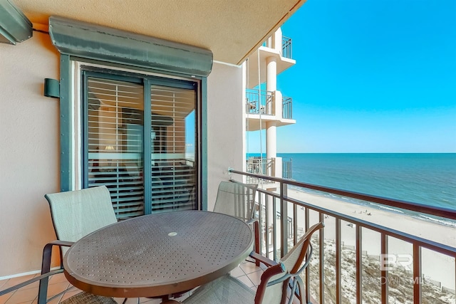 balcony with a beach view and a water view