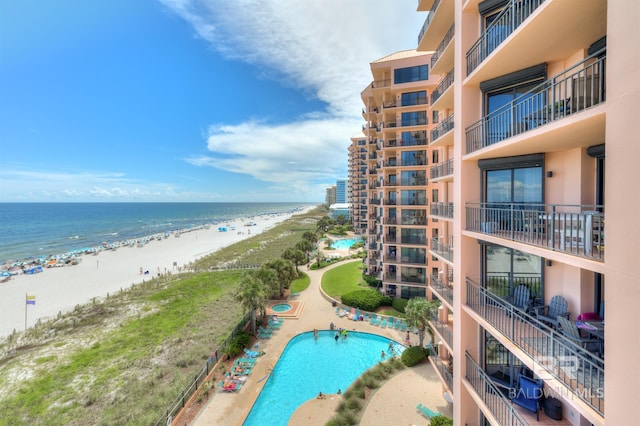 view of pool featuring a beach view and a water view