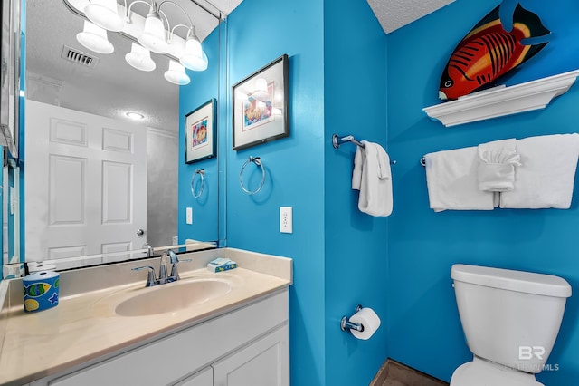 25250 Perdido Beach Blvd Unit 904E, Orange Beach, AL 36561 - bathroom with toilet, vanity, a textured ceiling, and visible vents
