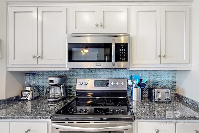 kitchen featuring white cabinetry, tasteful backsplash, and appliances with stainless steel finishes