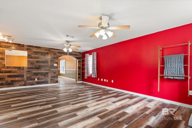 unfurnished room with ceiling fan and dark wood-type flooring