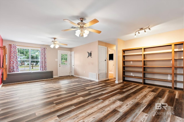 unfurnished living room featuring dark hardwood / wood-style floors and ceiling fan