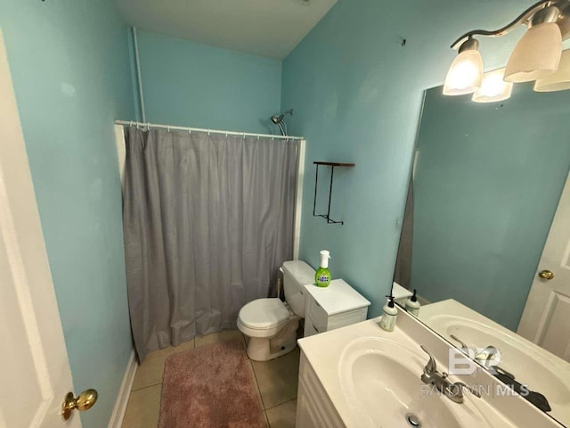 bathroom featuring toilet, curtained shower, tile patterned flooring, and vanity