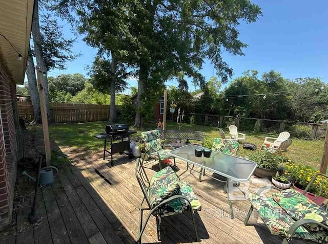 wooden terrace featuring outdoor dining area and area for grilling