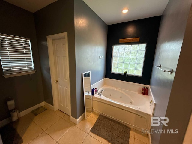 bathroom featuring tile patterned flooring, a whirlpool tub, baseboards, and recessed lighting