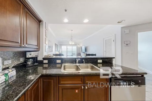 401 E Beach Blvd Unit 1804, Gulf Shores, AL 36542 - kitchen featuring a sink, stainless steel dishwasher, a peninsula, dark stone counters, and ornamental molding