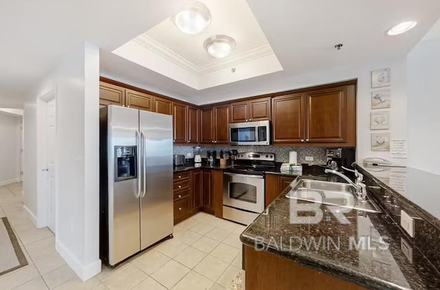 401 E Beach Blvd Unit 1804, Gulf Shores, AL 36542 - kitchen with stainless steel appliances, a tray ceiling, a sink, light tile patterned floors, and crown molding