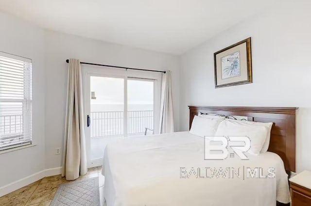 401 E Beach Blvd Unit 1804, Gulf Shores, AL 36542 - bedroom featuring access to exterior, multiple windows, and baseboards