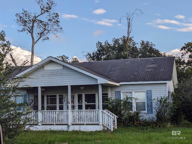 view of front of property featuring a porch and roof with shingles