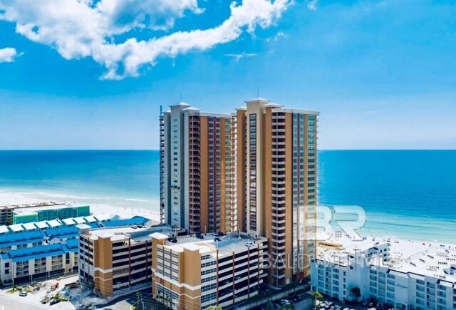 exterior space with a water view and a beach view