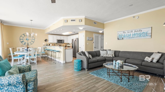 1524 W Beach Blvd Unit 603, Gulf Shores, AL 36542 - living area featuring light wood-style flooring, a chandelier, ornamental molding, and a textured ceiling