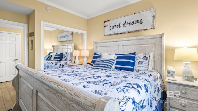 1524 W Beach Blvd Unit 603, Gulf Shores, AL 36542 - bedroom with ornamental molding, wood finished floors, and a closet
