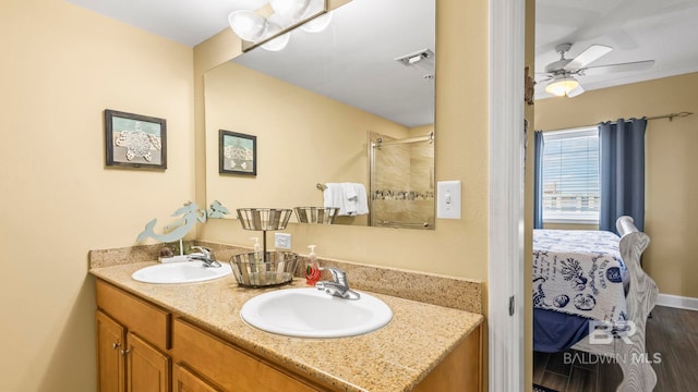 1524 W Beach Blvd Unit 603, Gulf Shores, AL 36542 - ensuite bathroom with a ceiling fan, an enclosed shower, wood finished floors, and double vanity