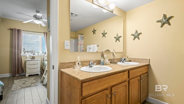 1524 W Beach Blvd Unit 603, Gulf Shores, AL 36542 - bathroom featuring ceiling fan, double vanity, and baseboards