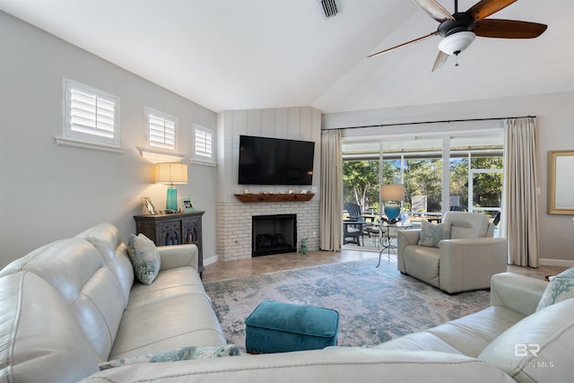 living room featuring a fireplace, ceiling fan, and lofted ceiling