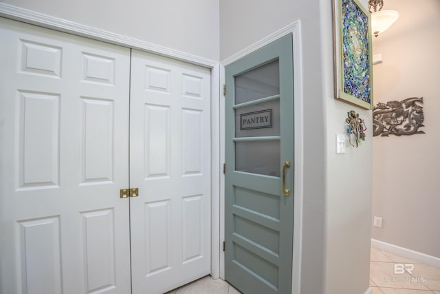 hall featuring light tile patterned floors