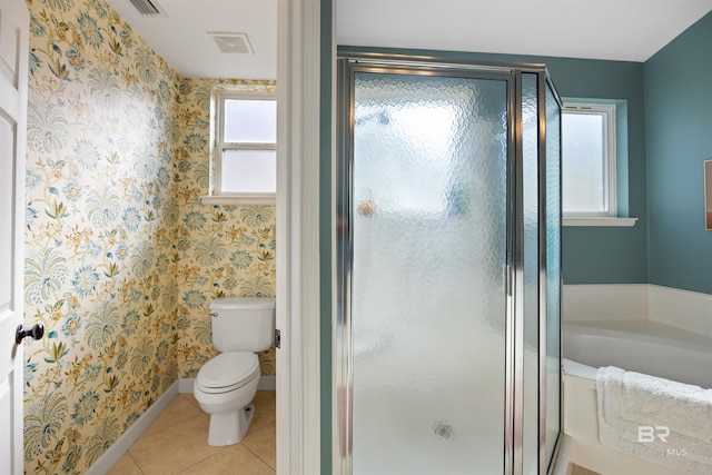 bathroom featuring tile patterned floors, plus walk in shower, and toilet
