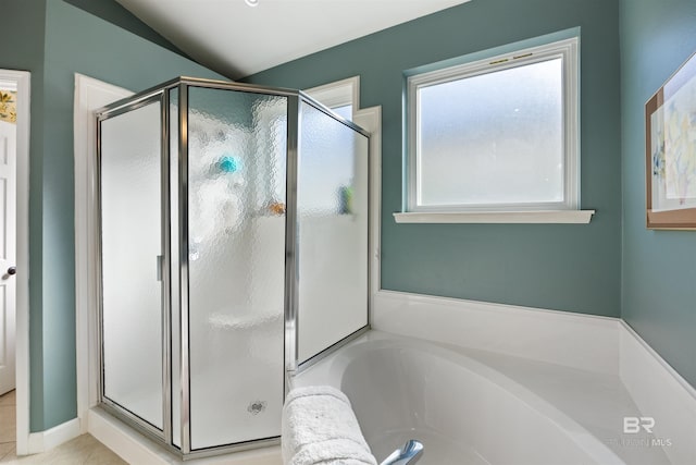 bathroom with shower with separate bathtub and vaulted ceiling