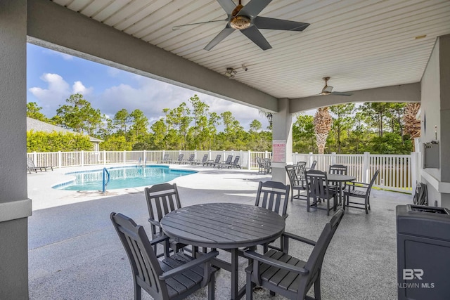 view of patio with ceiling fan and a fenced in pool