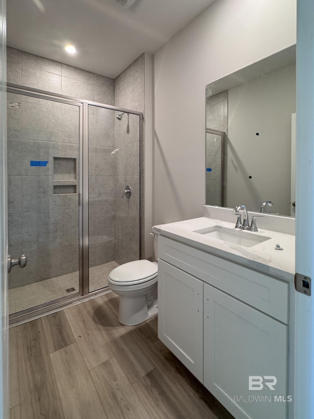 23850 Shadowridge Dr, Daphne, AL 36526 - bathroom featuring toilet, wood finished floors, vanity, and a shower stall