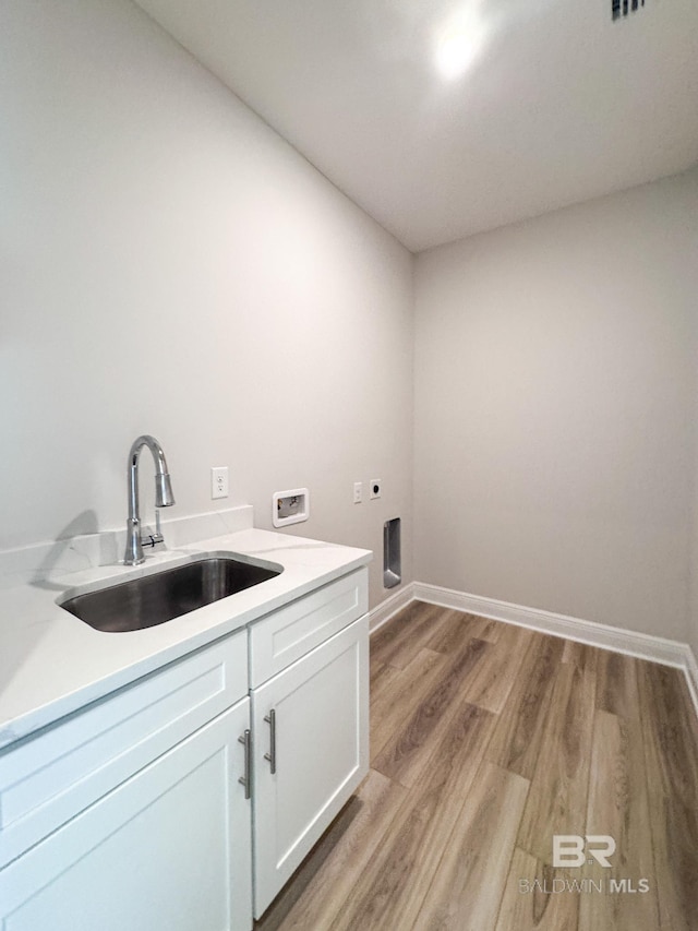 23850 Shadowridge Dr, Daphne, AL 36526 - laundry room with cabinet space, washer hookup, electric dryer hookup, light wood-type flooring, and baseboards