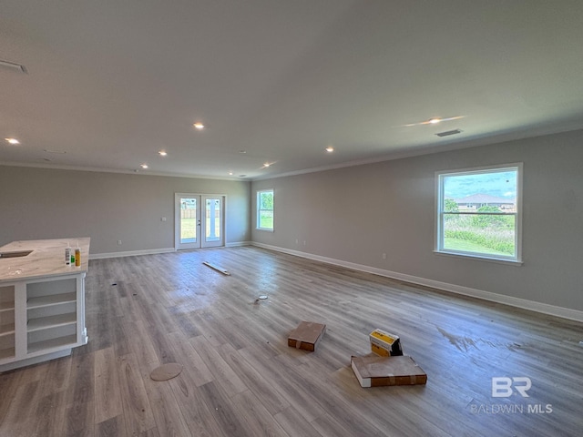 23850 Shadowridge Dr, Daphne, AL 36526 - unfurnished living room with ornamental molding, baseboards, recessed lighting, wood finished floors, and french doors